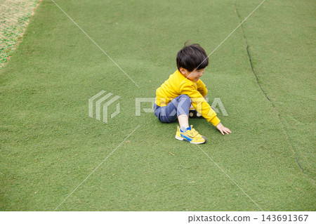 一個男孩在公園裡精力充沛地玩耍 143691367