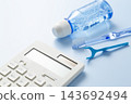 藍色背景上擺放著計算器和牙科護理產品。 143692494