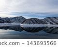 Snow-covered mountains and the winter mountain range reflected on the lake's surface. 143693566