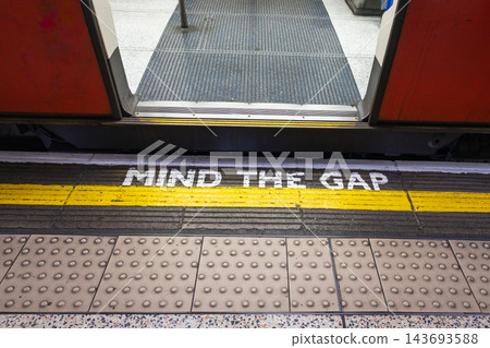 Mind the gap warning painted on an underground station platform Mind the gap warning painted on an underground station platform 143693588