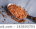 Flax seeds linseed on kitchen spoon 143693703