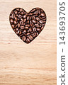 Heart shaped coffee beans on wooden board 143693705