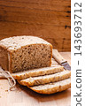 Sliced whole wheat bread on cutting board 143693712