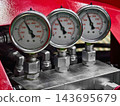 Pressure gauges mounted on industrial equipment in a workshop 143695679