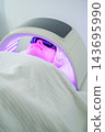 During an appointment at a beauty salon, the focus is on led light therapy, a woman, facial light therapy, led facial, phototherapy, and skincare treatment 143695990