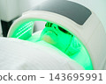 The beauty salon setting highlights a woman, protective goggles, led light therapy, facial light therapy, led facial, and skincare treatment 143695991