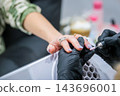 At a personal care studio, a focused care session includes a manicure, fingernails, an electric nail drill, a nail drill, a nail technician, nail filing, and a manicurist 143696001