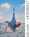 Beach scene featuring camatkarasana, wild thing pose, a young woman, a woman, yoga, and practicing yoga 143696017