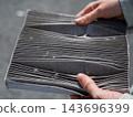 A woman shows a dirty car cabin air filter. 143696399