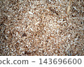 Wood shavings and sawdust texture close up with natural earthy tones 143696600