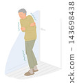 A senior man walks down a cold winter corridor without a jacket, posing a risk of heat shock. 143698438