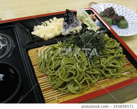 Shimizuya's kusa dango (rice dumplings with mugwort), green tea soba noodles, and shrimp tempura in front of Nishiarai Daishi Temple. Shimizuya's kusa dango (rice dumplings with mugwort), green tea soba noodles, and shrimp tempura in front of Nishiarai Daishi Temple. 143698571