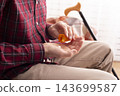 Senior Man Taking Medication at Home 143699587