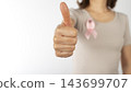 Woman Giving Thumbs Up with Pink Breast Cancer Awareness Ribbon on White Background 143699707