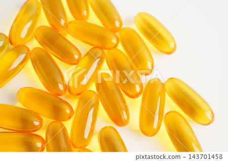 Fish oil or Cod liver oil gel in capsules with omega 3 vitamins, supplementary healthy food. Fish oil or Cod liver oil gel in capsules with omega 3 vitamins, supplementary healthy food. 143701458