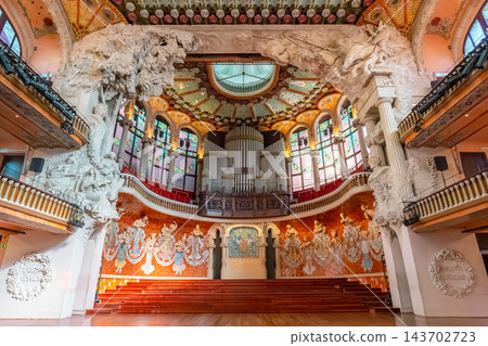 Ornate modernista concert hall with stained glass skylight, ceramic roses and chandeliers in Palau de la Musica Catalana, Barcelona Ornate modernista concert hall with stained glass skylight, ceramic roses and chandeliers in Palau de la Musica Catalana, Barcelona 143702723