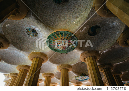 Colorful sun mosaic medallion on the ceiling of the Hypostyle Room in Park Guell Barcelona Colorful sun mosaic medallion on the ceiling of the Hypostyle Room in Park Guell Barcelona 143702758