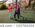 Elderly woman trains with a fitness coach on outdoor gym equipment during medical recovery. Sport improves mobility, endurance, and long term wellbeing. 143704204