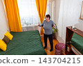 Senior woman dancing to rhythmic songs in comfortable room. Carefree retirement and modern lifestyle. Concept of emotional wellness. Top view 143704215