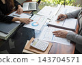 Cropped image of professional businesswoman, entrepreneur or accountant working on a financial report paperwork at her desk, using calculator or laptop 143704571