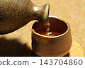 Bizen ware sake bottle and sake cup 143704860
