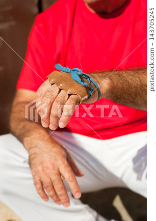 Close-Up of Male Athlete Hand Wearing Leather Sports Glove Close-Up of Male Athlete Hand Wearing Leather Sports Glove 143705245