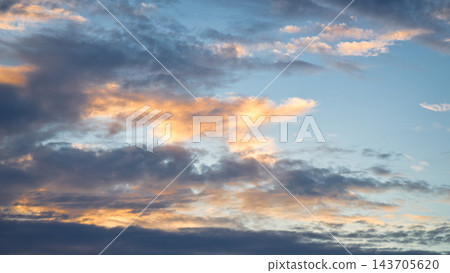 Dramatic Sunset Sky with Golden Clouds and Blue Twilight Dramatic Sunset Sky with Golden Clouds and Blue Twilight 143705620