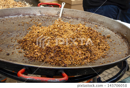 Traditional Spanish Paella with Squid and Rice Cooking in Giant Traditional Spanish Paella with Squid and Rice Cooking in Giant 143706058