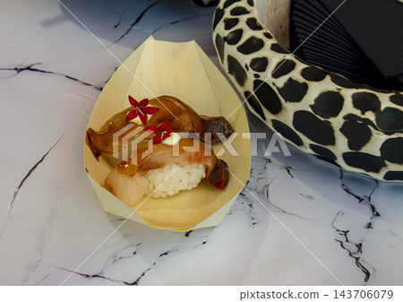 Gourmet Japanese Nigiri Sushi with Glazed Fish and Edible Flower Gourmet Japanese Nigiri Sushi with Glazed Fish and Edible Flower 143706079