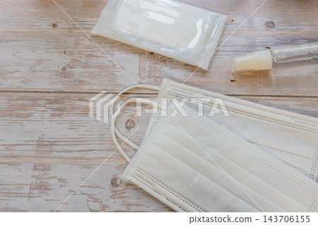 圖片展示了一個不織布口罩，配有用於病毒消毒和感染控制的濕紙巾和噴霧劑。 143706155