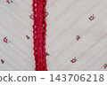 White fabric texture in cherry and flowers. Fabric with burgundy lace. 143706218