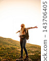 Young woman hiking mountain enjoying freedom and nature at sunset 143706405