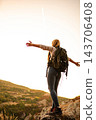 Woman hiking mountain summit feeling freedom at sunset 143706408