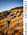 Woman hiking mountain path enjoying nature and healthy lifestyle 143706415