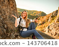 Woman hiking in mountains taking selfie video call 143706418