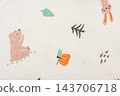 Macro photo of clothes for newborns. Texture of knitted light beige fabric with autumn print for children. 143706718