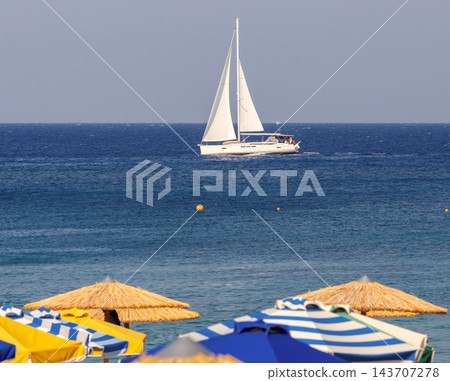 Sailing Yacht on the Aegean Sea Near Rhodes Beach, Greece Sailing Yacht on the Aegean Sea Near Rhodes Beach, Greece 143707278