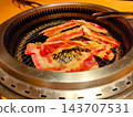 Thinly sliced beef grilled on a grill and a yakiniku roaster. 143707531