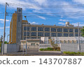 Exterior view and main gate of Showa Gakuin Shuei Junior and Senior High School, against a blue sky [Wakaba, Mihama Ward, Chiba City, Chiba Prefecture] 143707887