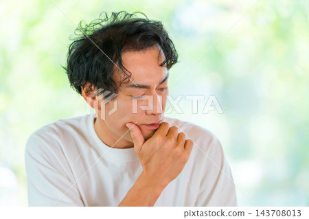 一位四十多歲的男子,手托下巴,陷入沉思。圖片展現了男士美容和抗衰老護理的概念。 一位四十多歲的男子,手托下巴,陷入沉思。圖片展現了男士美容和抗衰老護理的概念。 143708013