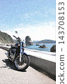 A motorcycle riding along the coast in summer 143708153