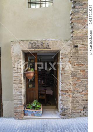 The image shows the entrance to an Osteria, a small Italian restaurant, in Urbino, Italy The image shows the entrance to an Osteria, a small Italian restaurant, in Urbino, Italy 143711085