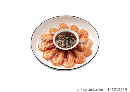 Cooked whole shrimp arranged in a circle on a white plate with a garlic soy dipping sauce, isolated on a white background 143712829