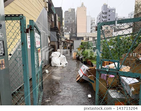 一條雜亂、下著雨的小巷 一條雜亂、下著雨的小巷 143713204