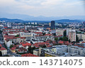 Cityscape and skyscrapers overlooking the evening sky and mountain range 143714075