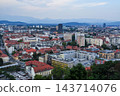 An aerial view of the city with red roofs and market stalls. 143714076