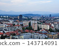 A distant view of a city with mountain ranges and skyscrapers. 143714091
