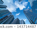 Low angle of high-rise business buildings in city with blue sky 143714487