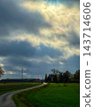 Serene countryside scene, Tranquil natural setting under cloudy skies 143714606