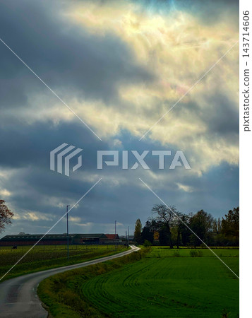 Serene countryside scene, Tranquil natural setting under cloudy skies Serene countryside scene, Tranquil natural setting under cloudy skies 143714606